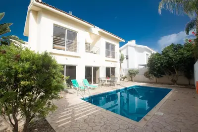 a villa with a swimming pool in front of a house at Protaras Delfini Villa Dv5 in Protaras