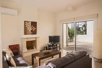 a living room with a couch and a tv at Protaras Delfini Villa Dv5 in Protaras