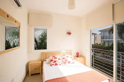a bedroom with a bed and a large window at Protaras Delfini Villa Dv5 in Protaras