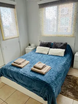 a bedroom with a bed with two towels on it at Carisa Holiday rooms in Larnaka