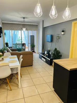 a living room with a couch and a table at Carisa Holiday rooms in Larnaka