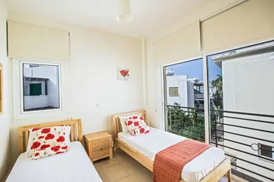 a bedroom with two beds and a large window at Villa Delfini 5 in Protaras