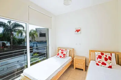 a small room with a bed and a balcony at Villa Delfini 5 in Protaras