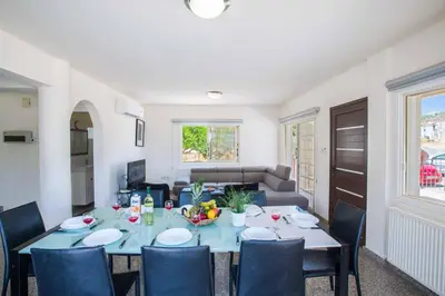 a dining room with a table and chairs at Villa Delfini 16 in Protaras