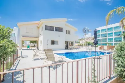 a balcony with a swimming pool and a house at Villa Delfini 16 in Protaras