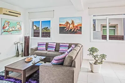 a living room with a couch and a table at Villa Mesogeios ME25 in Protaras