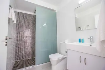 a bathroom with a shower and a toilet and a sink at Protaras Greco Villa CCV2 in Protaras