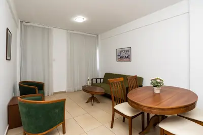 a living room with a table and chairs at Flora Hotel Apartments in Protaras