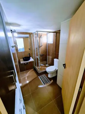 a small bathroom with a toilet and a shower at Ayia Anna Apartment in Ayia Napa