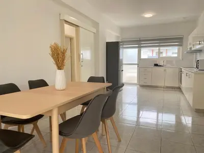 a kitchen and dining room with a wooden table and chairs at Phaedrus Living Down Town Flat Nestoras 301 in Limassol