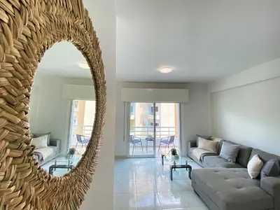 a living room with a couch and a mirror at Phaedrus Living Down Town Flat Nestoras 301 in Limassol