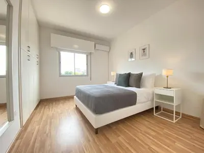 a white bedroom with a bed and a window at Phaedrus Living Down Town Flat Nestoras 301 in Limassol