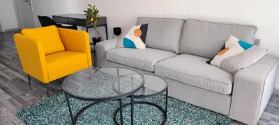 a living room with a couch and a table and a chair at Zinas modern flat Nicosia in Strovolos