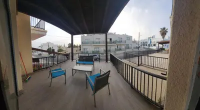 a balcony with two chairs and a table on it at Ayia Napa sea view great location bars & beach in Ayia Napa