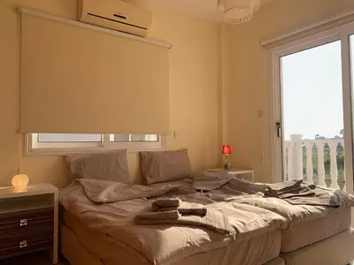 a bed with two towels on it in a bedroom at Sunset Sea View Villa in Ayia Napa
