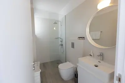 a bathroom with a sink and a toilet and a mirror at Protaras Olivine Villa Ol9 in Protaras