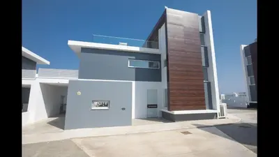 a large white building with a brown at Protaras Olivine Villa Ol10 in Protaras