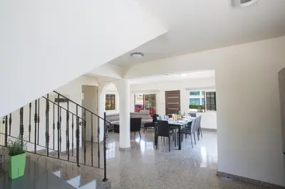 a dining room and living room with a dining table at Protaras Holiday Villa Dv16 in Protaras