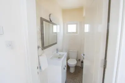 a white bathroom with a toilet and a sink at Protaras Holiday Villa Dv16 in Protaras