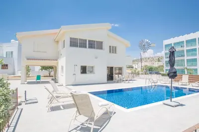 a villa with a swimming pool and lounge chairs at Protaras Holiday Villa Dv16 in Protaras