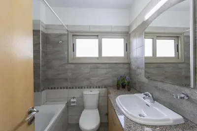 a bathroom with a toilet and a sink and a tub at Protaras Sunrise Beach Villa 2 in Protaras