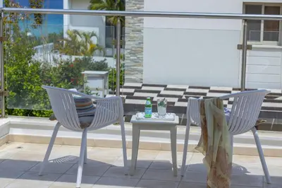 two chairs and a table on a patio at Protaras Sunrise Beach Villa 2 in Protaras