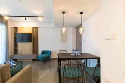 a living room with a table and chairs at The Quality Lodge - Self Check-in in Voroklini
