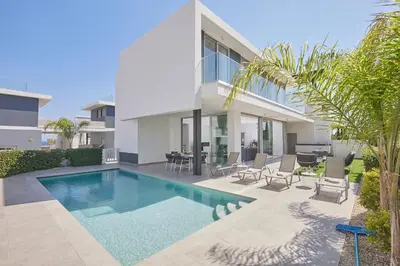 a swimming pool in the backyard of a house at Protaras Olivine Villa Ol13 in Protaras