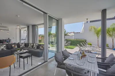 a living room with a couch and a table at Protaras Olivine Villa Ol13 in Protaras