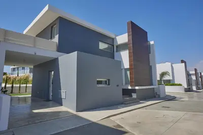 a modern house with a blue and white facade at Protaras Olivine Villa Ol13 in Protaras