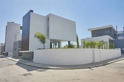 a white wall in front of a building at Protaras Olivine Villa Ol13 in Protaras