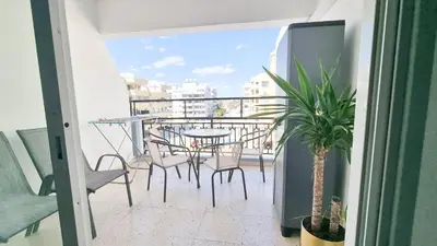 a balcony with a table and chairs and a table at Modern Retreat: 2br Stylish Apt with Comfy Rooms! Smart TV with 200MBPS Internet in Larnaka