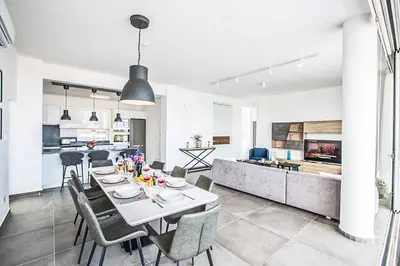 a dining room and kitchen with a table and chairs at Villa Olivine Pearl 6 in Protaras