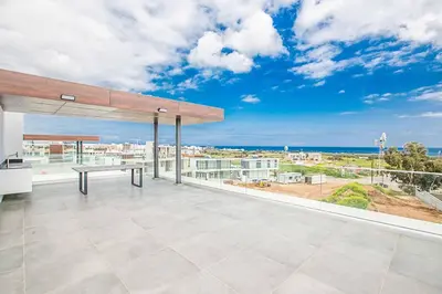 a view of the ocean from the balcony of a house at Villa Olivine Pearl 6 in Protaras