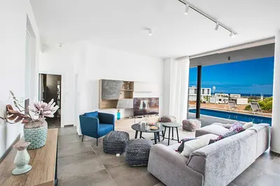 a living room with a couch and a table at Villa Olivine Pearl 6 in Protaras