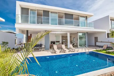 a villa with a swimming pool in front of a house at Olivine Pearl OL20 in Protaras