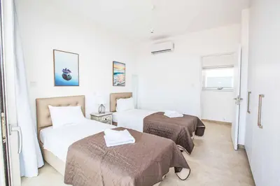 a hotel room with two beds and a window at Olivine Pearl OL20 in Protaras