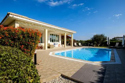 a swimming pool in front of a house at Cape Greco Villa Anastel 2 in Ayia Napa