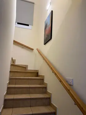 a staircase with a white wall and a picture on the wall at Moonlight Sea View Villa in Ayia Napa