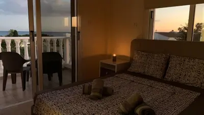 a bedroom with a bed with a candle and a balcony at Moonlight Sea View Villa in Ayia Napa