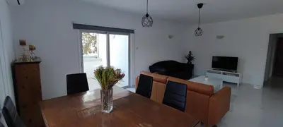 a living room with a wooden table and a couch at Ellas Modern Duplex City Center in Nicosia