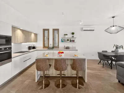 a kitchen with a table and a dining room at Azure Villas by Marc in Protaras