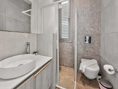 a bathroom with a sink and a toilet at Azure Villas by Marc in Protaras