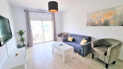 a living room with a couch and two chairs and a tv at Coastal Getaway: 2 Apartments for up to 14 guests! Light-flooded and Spacious in Larnaka