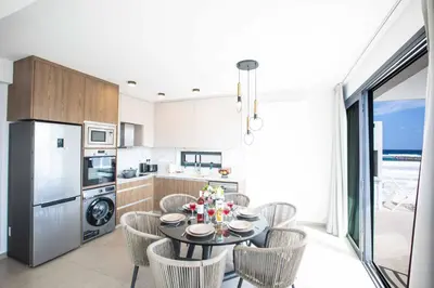 a kitchen and dining room with a table and chairs at Protaras Holiday Villa TI39 in Paralimni