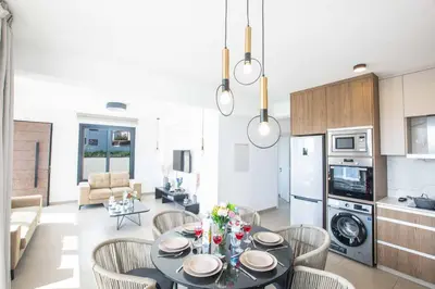 a kitchen and living room with a table and chairs at Protaras Holiday Villa TI39 in Paralimni