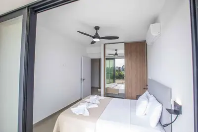 a bedroom with a bed with a large mirror at Protaras Holiday Villa TI39 in Paralimni