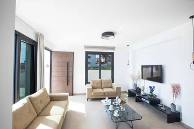 a living room with a couch and a table at Protaras Holiday Villa TI39 in Paralimni