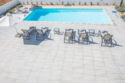 a group of chairs and a swimming pool at Protaras Greco Villa CCV5 in Protaras