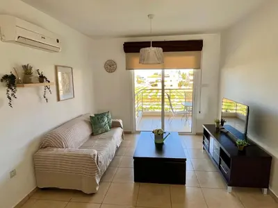 a living room with a couch and a table at Mythical Sands Holiday Apartment in Paralimni